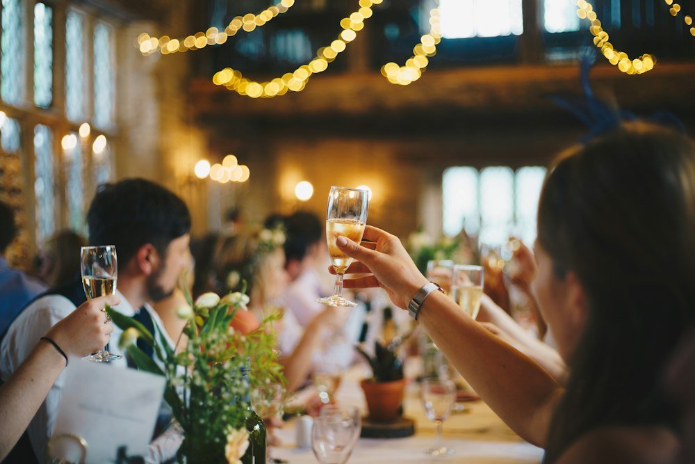 Friends toasting under fairy lights