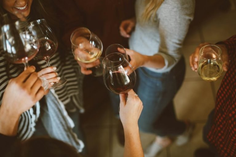 Friends clinking wine glasses together